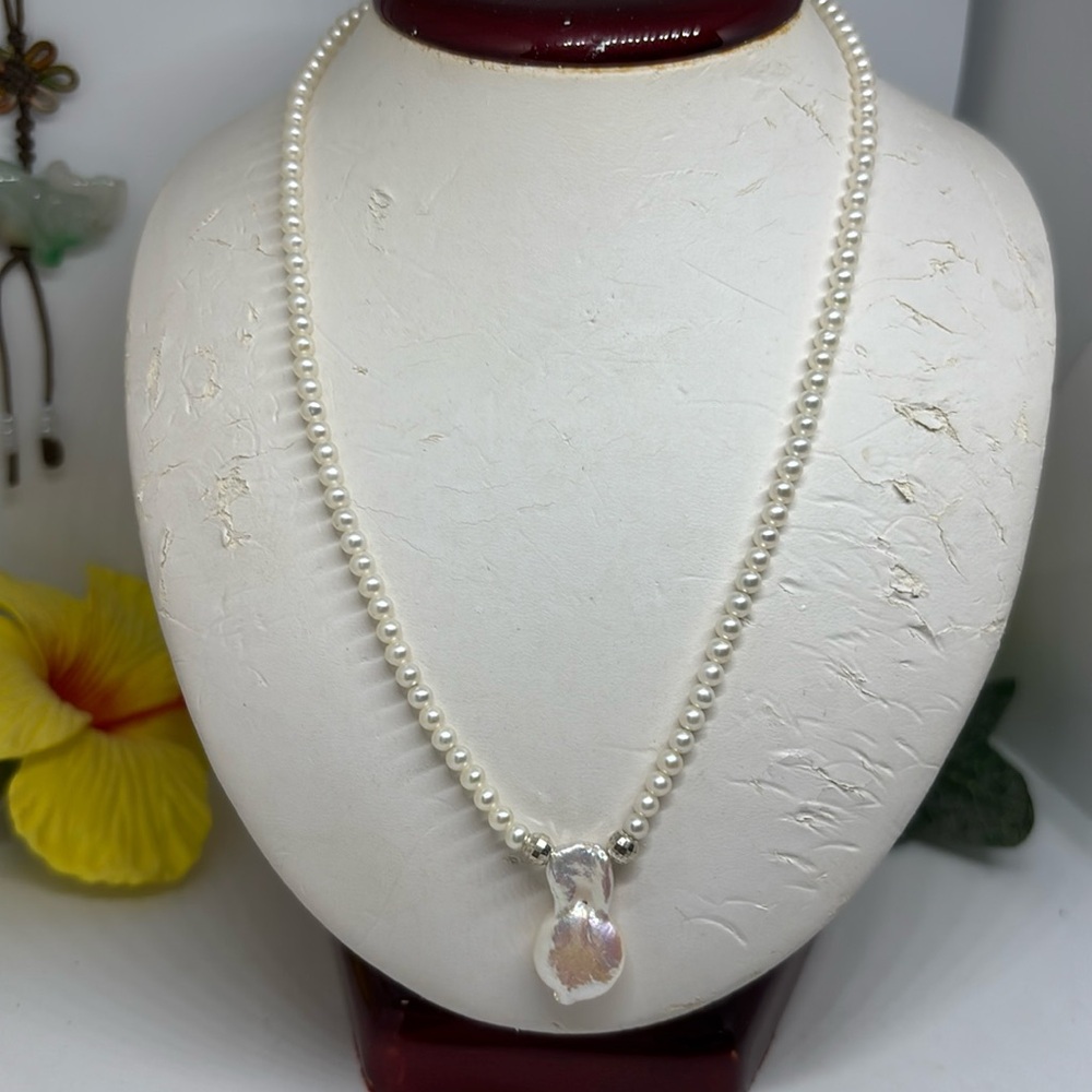 3mm Culture freshwater pearl necklace. With a drop dance pearl on Silver clasp